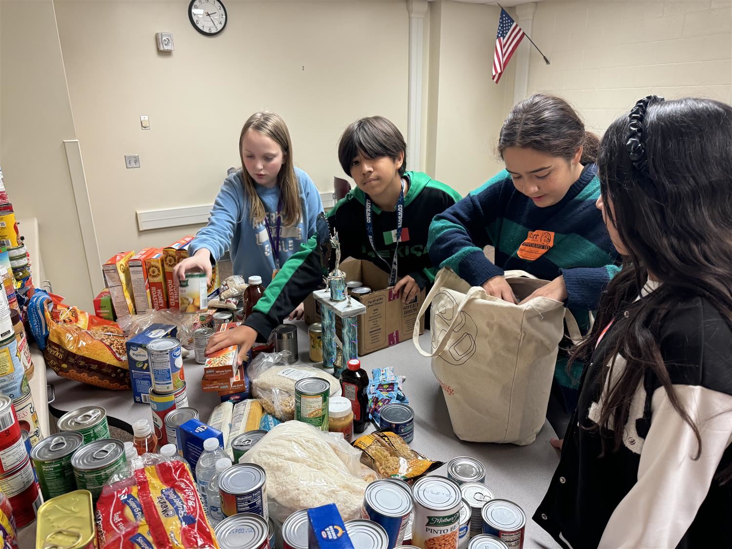 Barr Middle School students unpacking donated goods for Hope Harbor. 